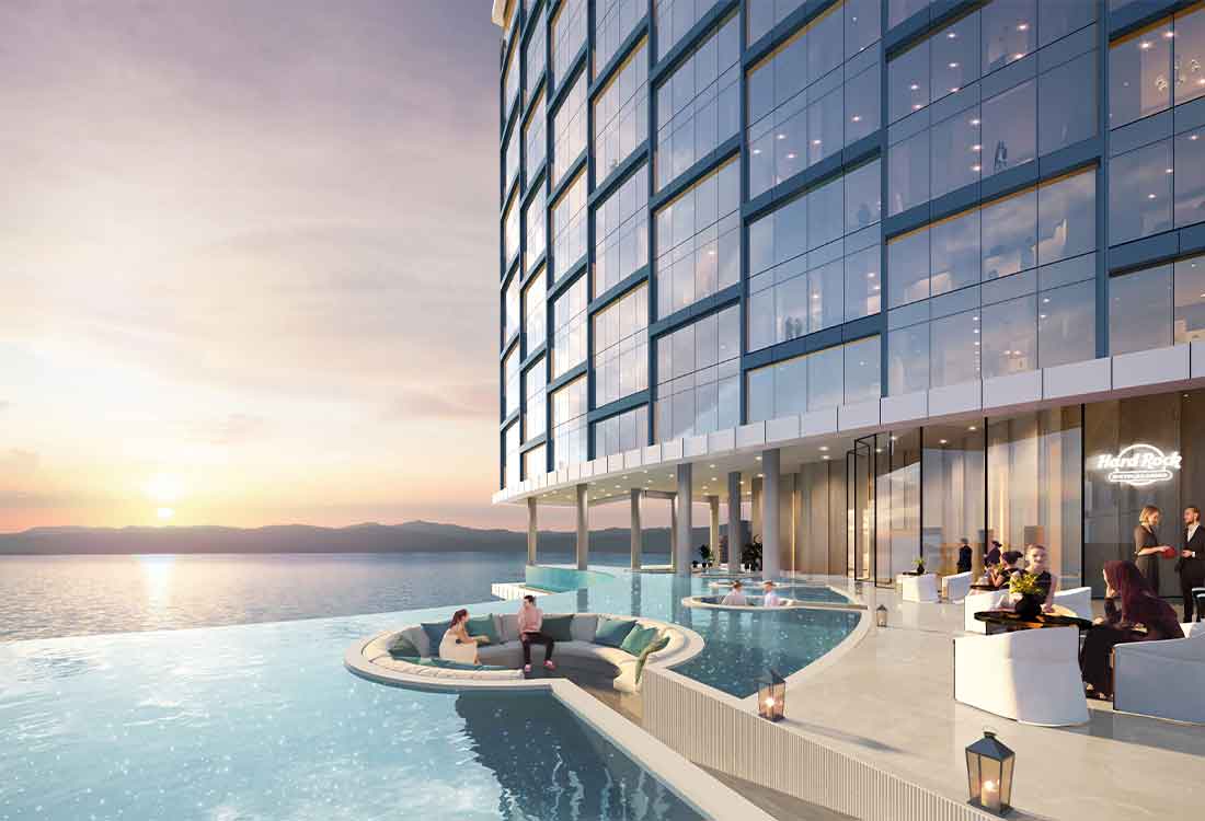 Luxury waterfront hotel infinity pool at sunset