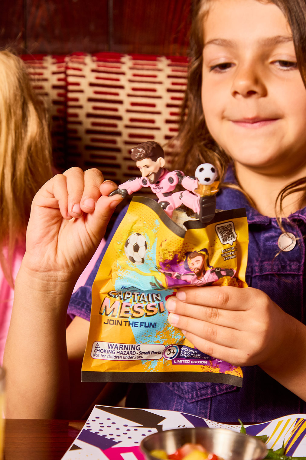 a girl holding a toy