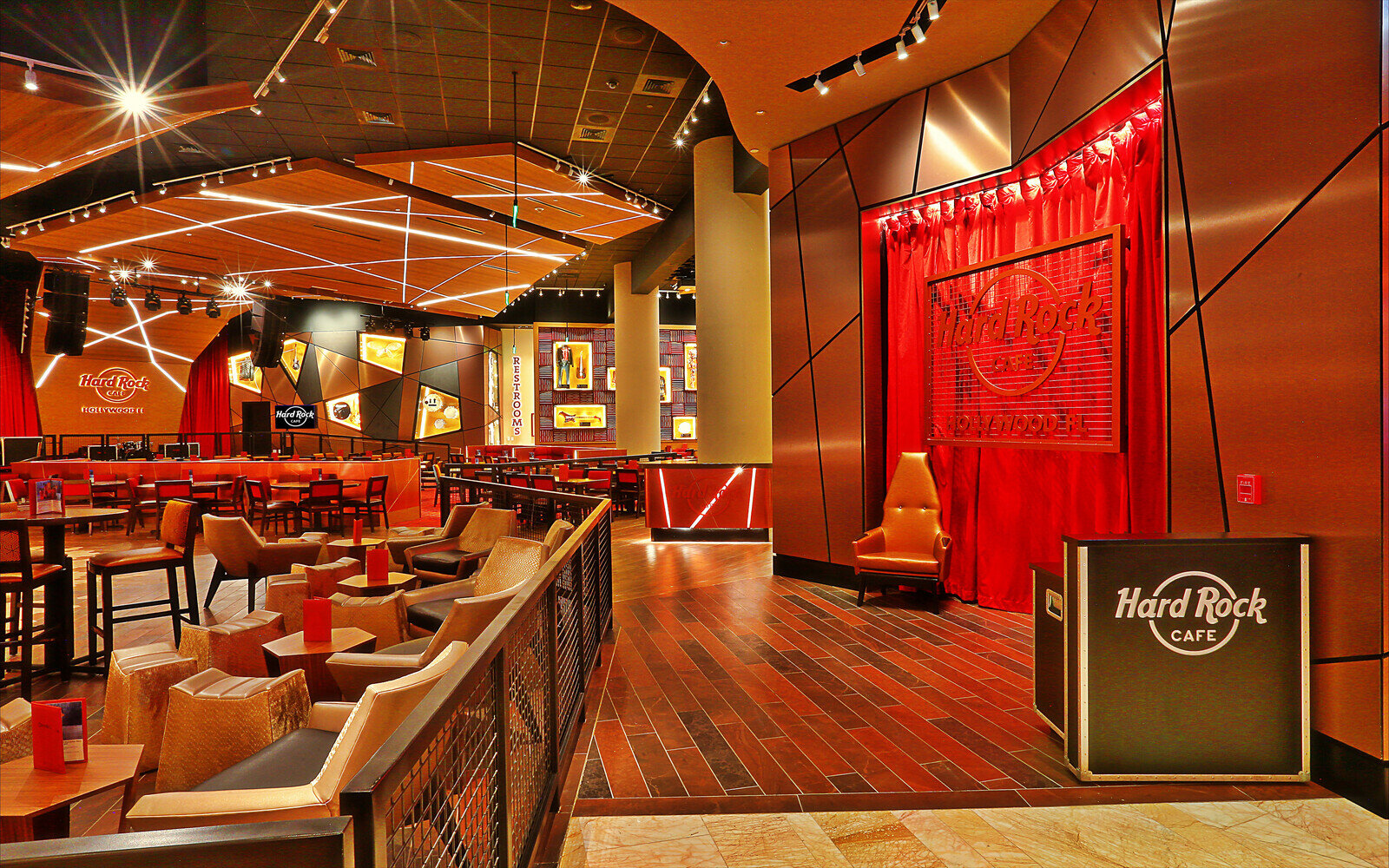 a room with a red curtain and chairs
