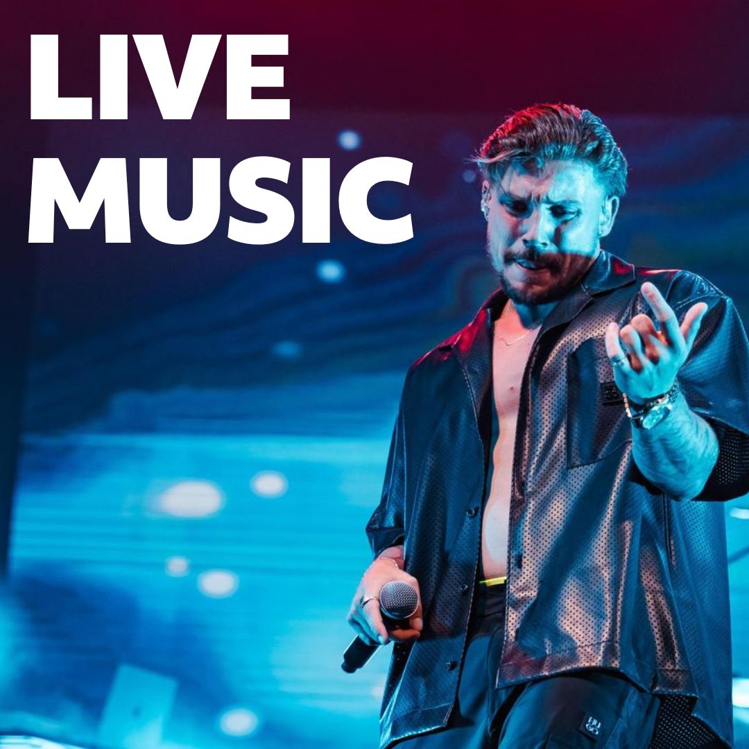 a man on stage with microphone