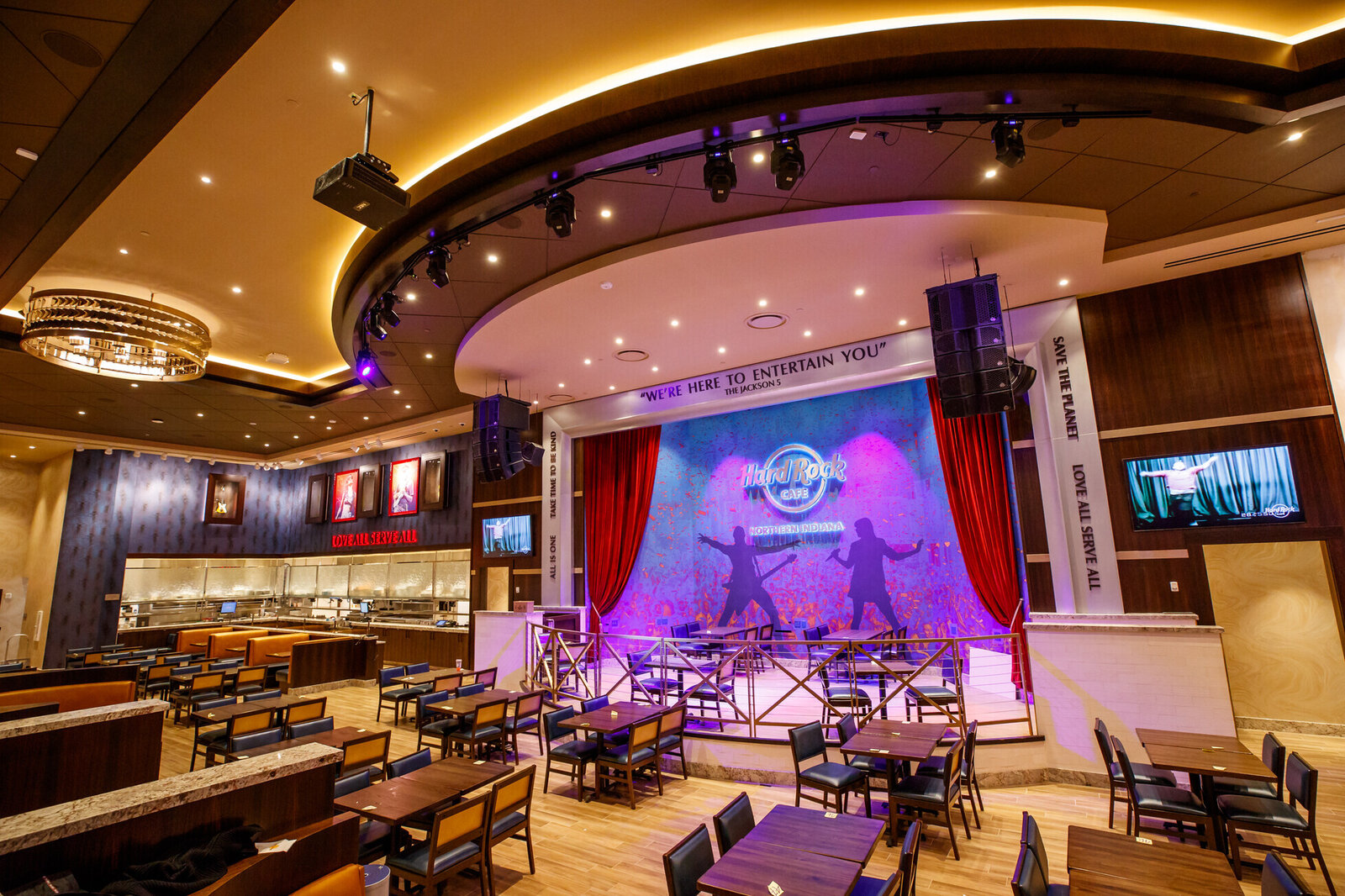 a room with tables and chairs and a stage