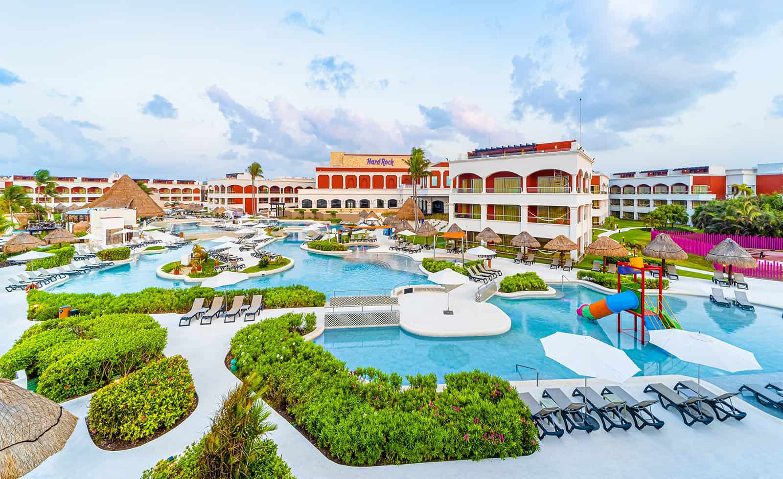 a pool with a slide and a building