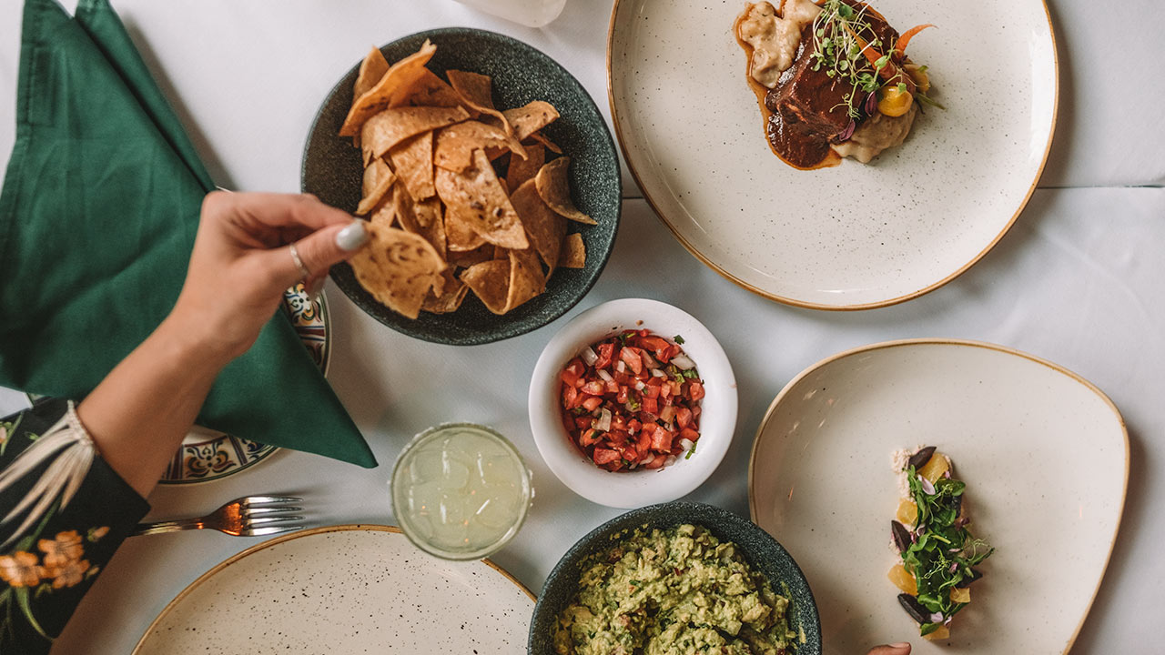 a table with plates of food and drinks
