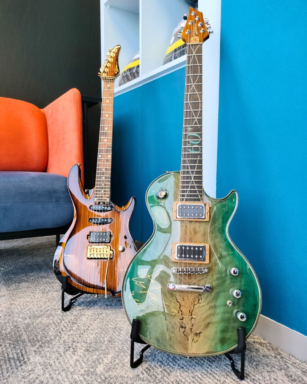 two guitars on display against a wall