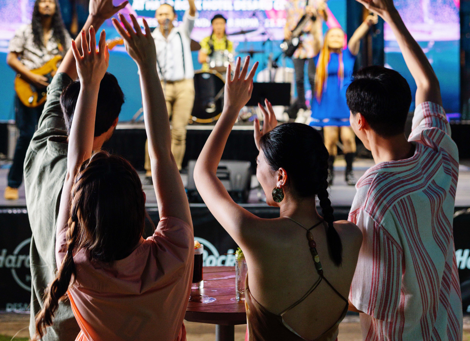a group of people raising their hands