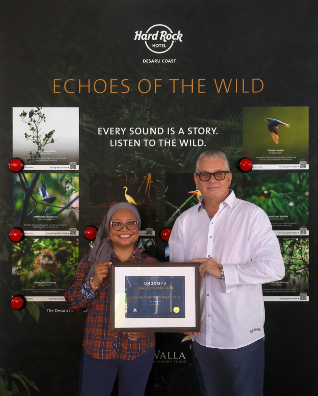 a man and woman holding a framed picture