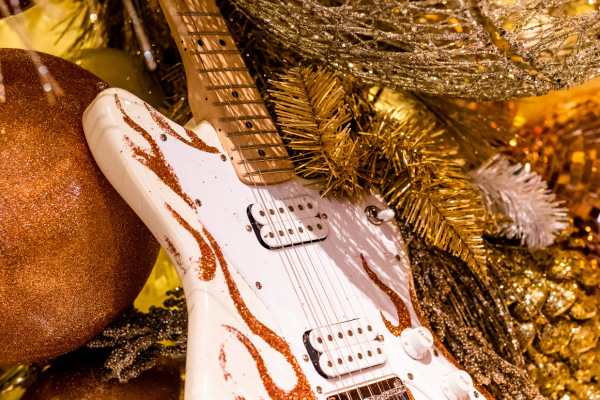 a white electric guitar with gold and silver decorations