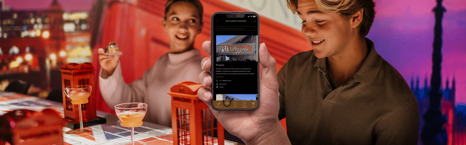 a man and woman taking a picture of a cell phone