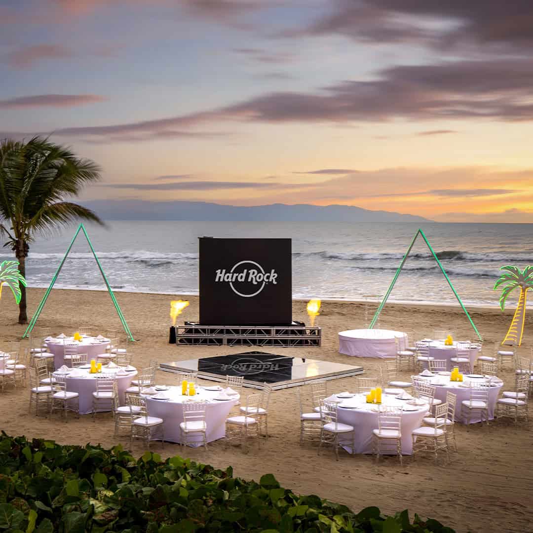 a group of tables and chairs on a beach