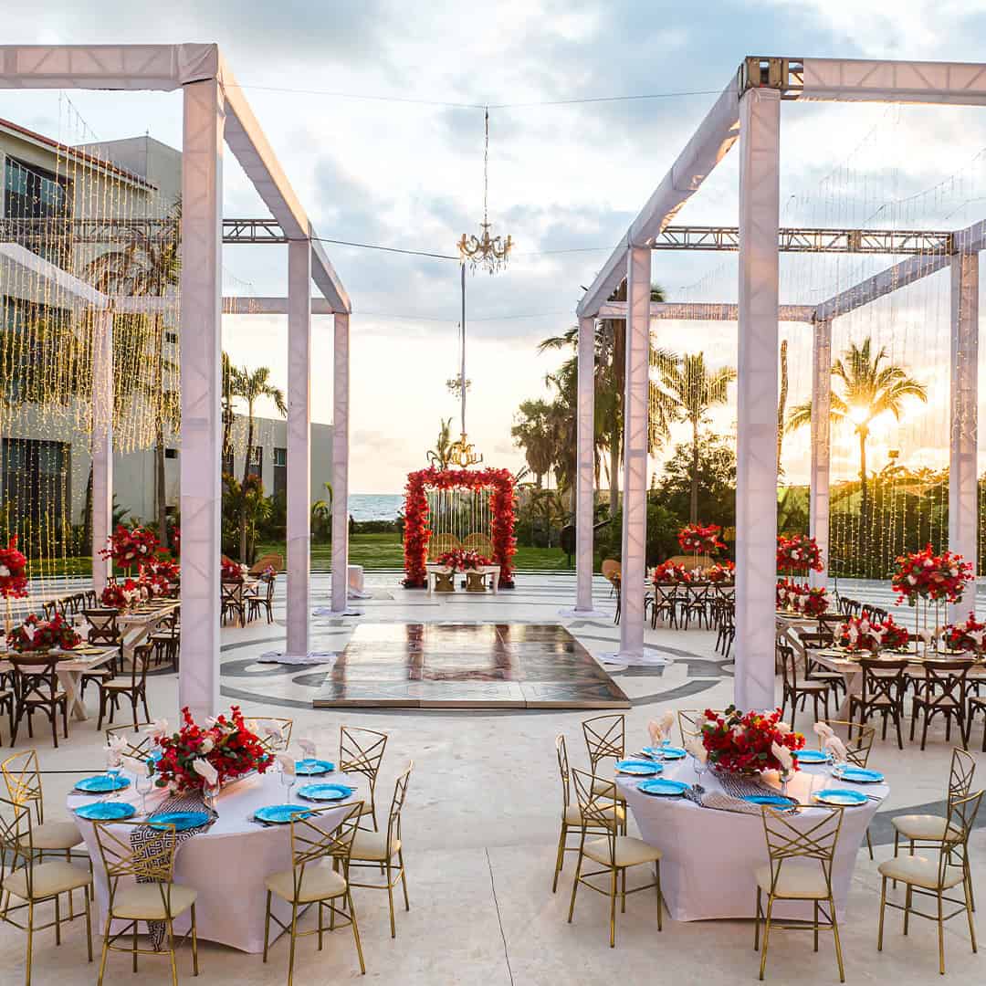 a outdoor wedding reception area with tables and chairs