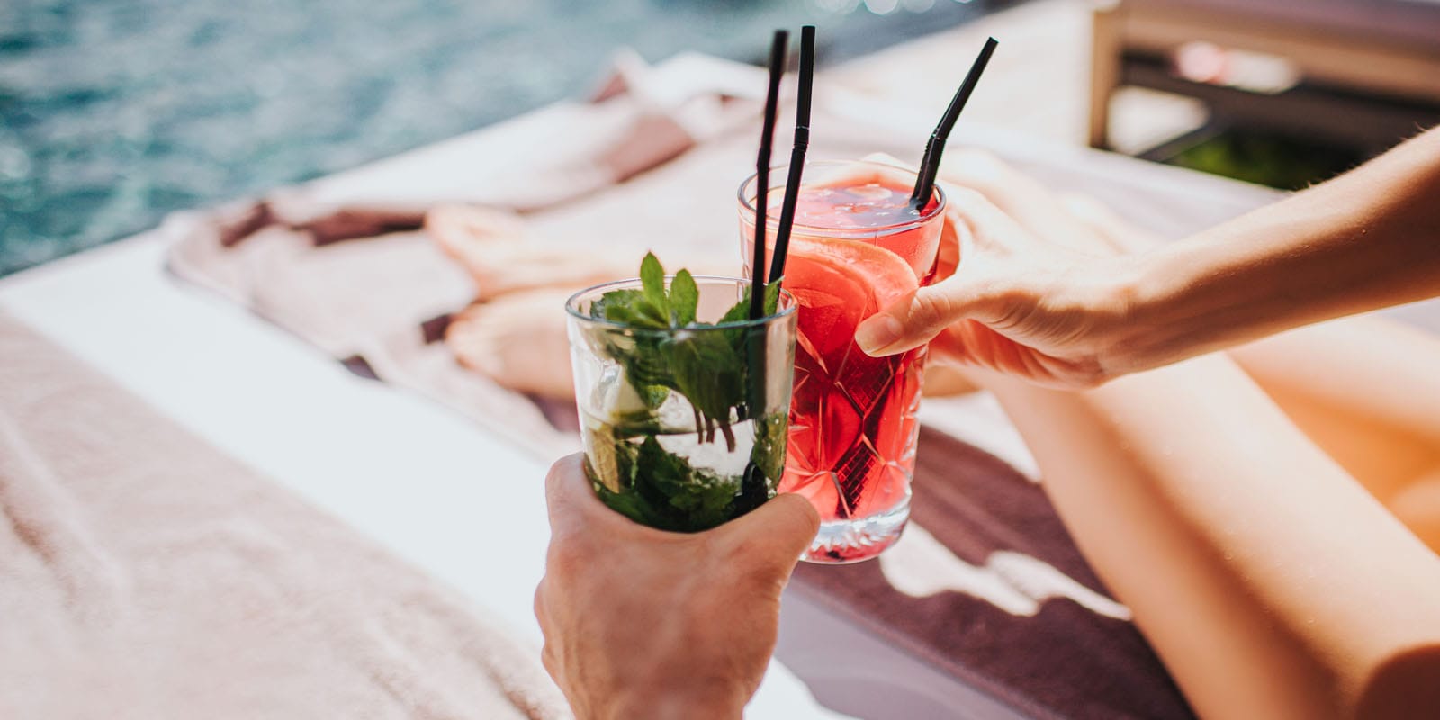 a pair of hands holding drinks